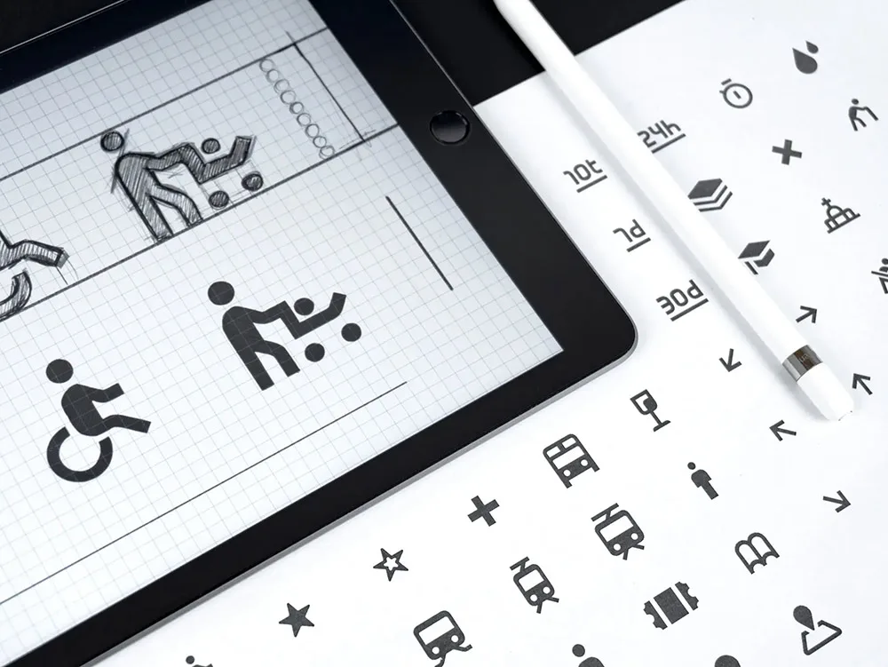 A variety of iconography featured on an iPad and printed design.