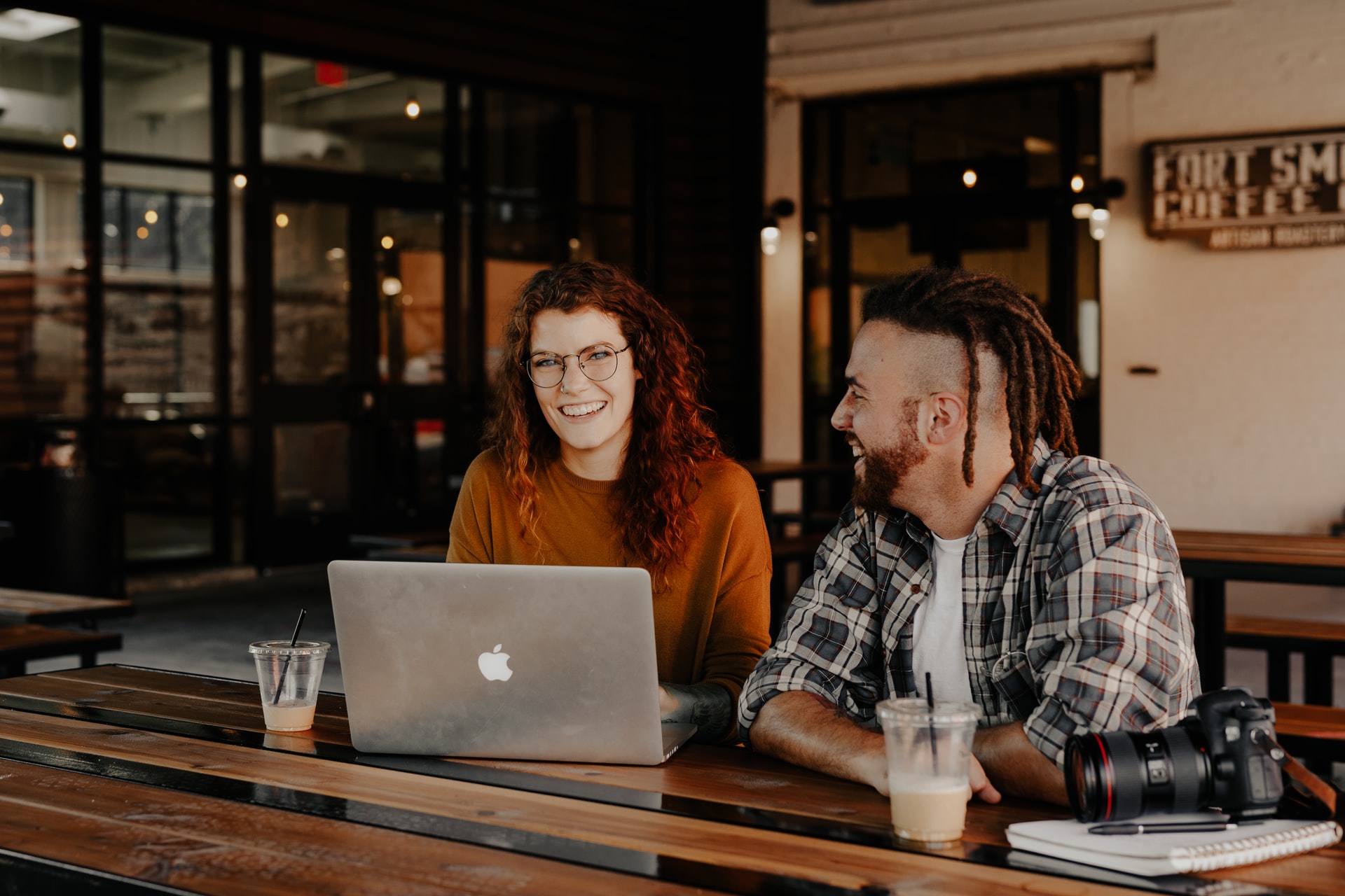 Two social media strategists collaborating on a laptop.