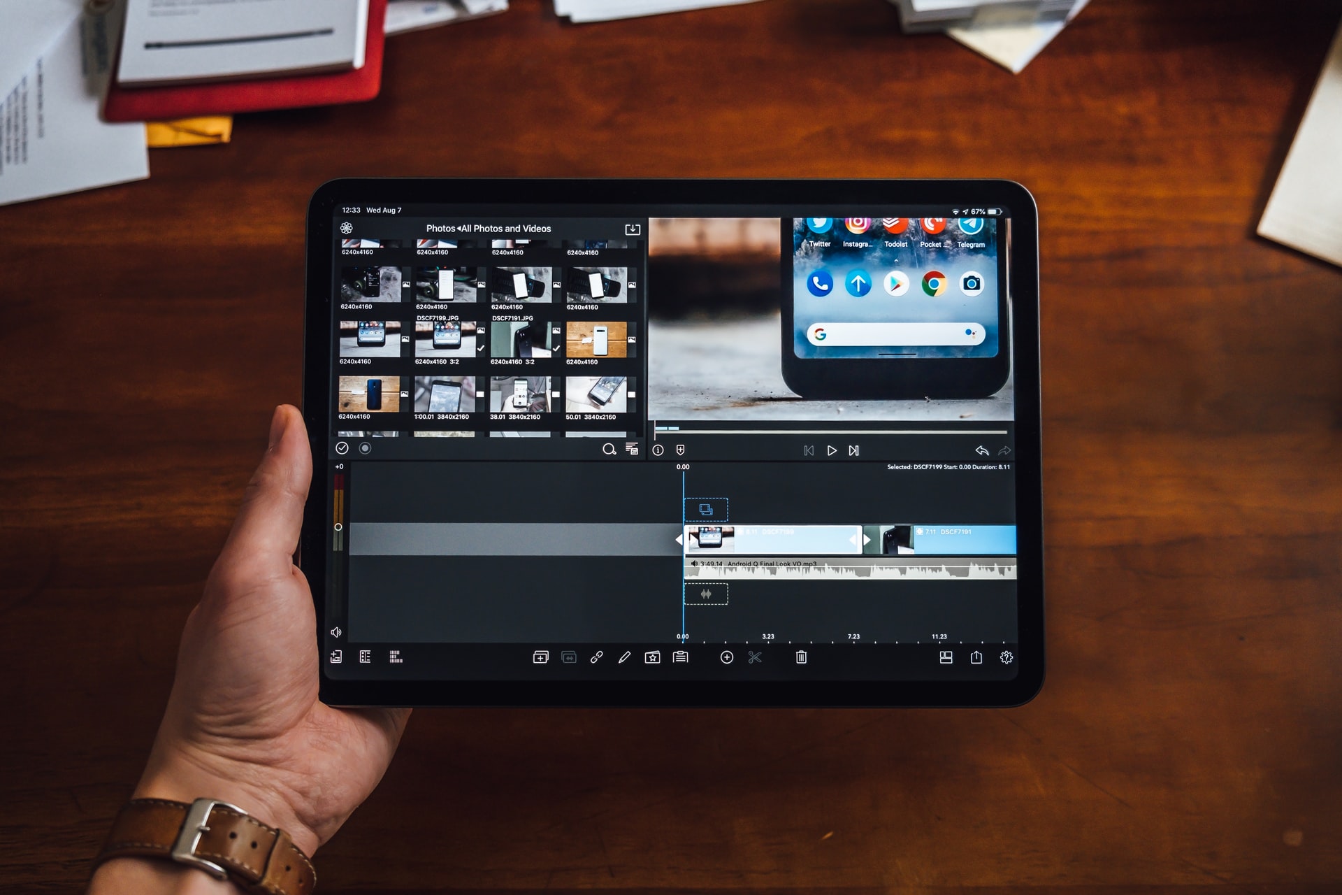 A person on an iPad using a video editing app.