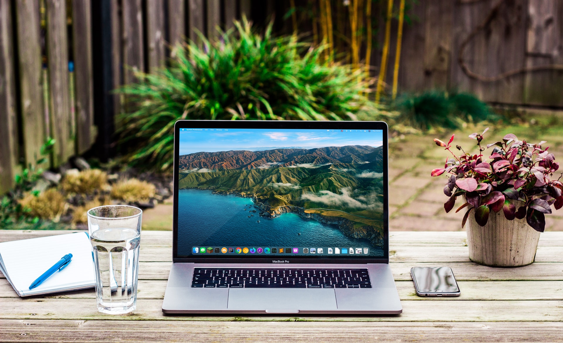 A laptop showcasing a mountain side screensaver.