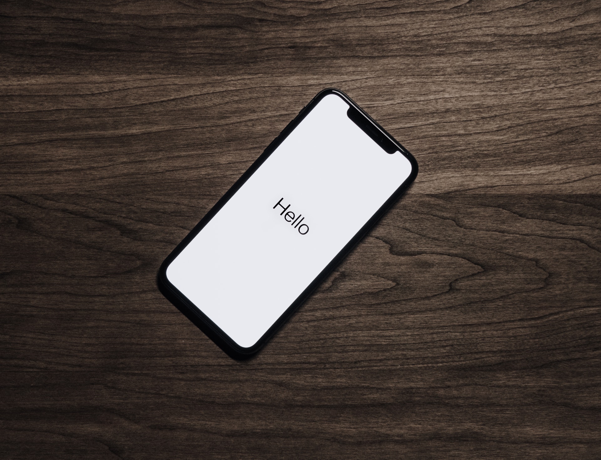 Mobile Design that reads 'Hello' on the screen.