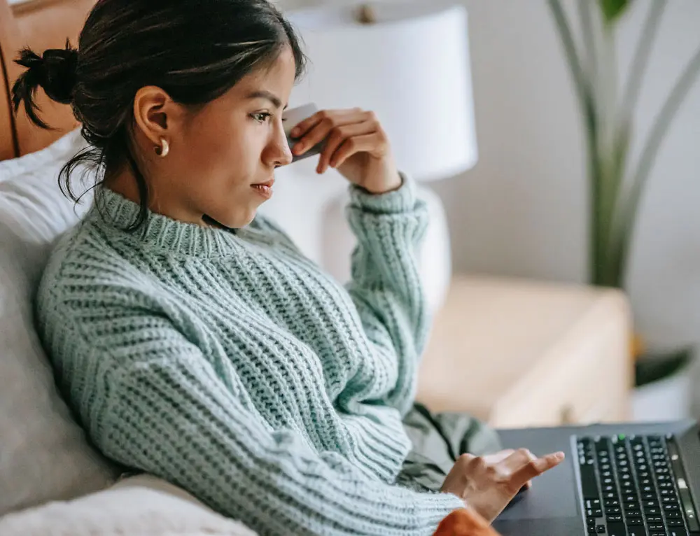 A person searches an e-commerce site on laptop.