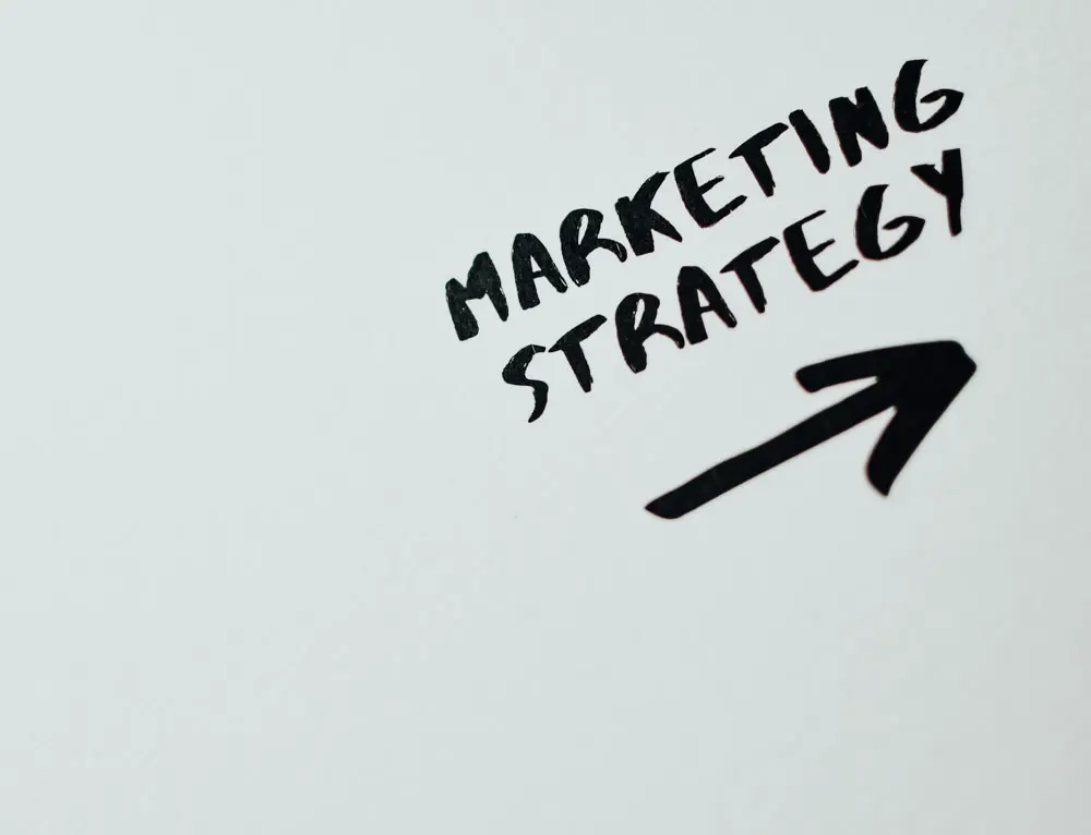 The words marketing strategy appear with an arrow under it.