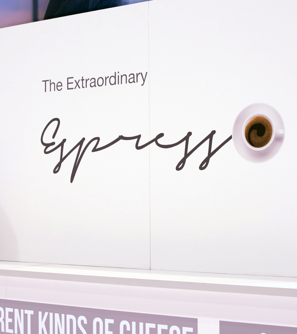 A Trade show booth design that features "expresso" on a banister.