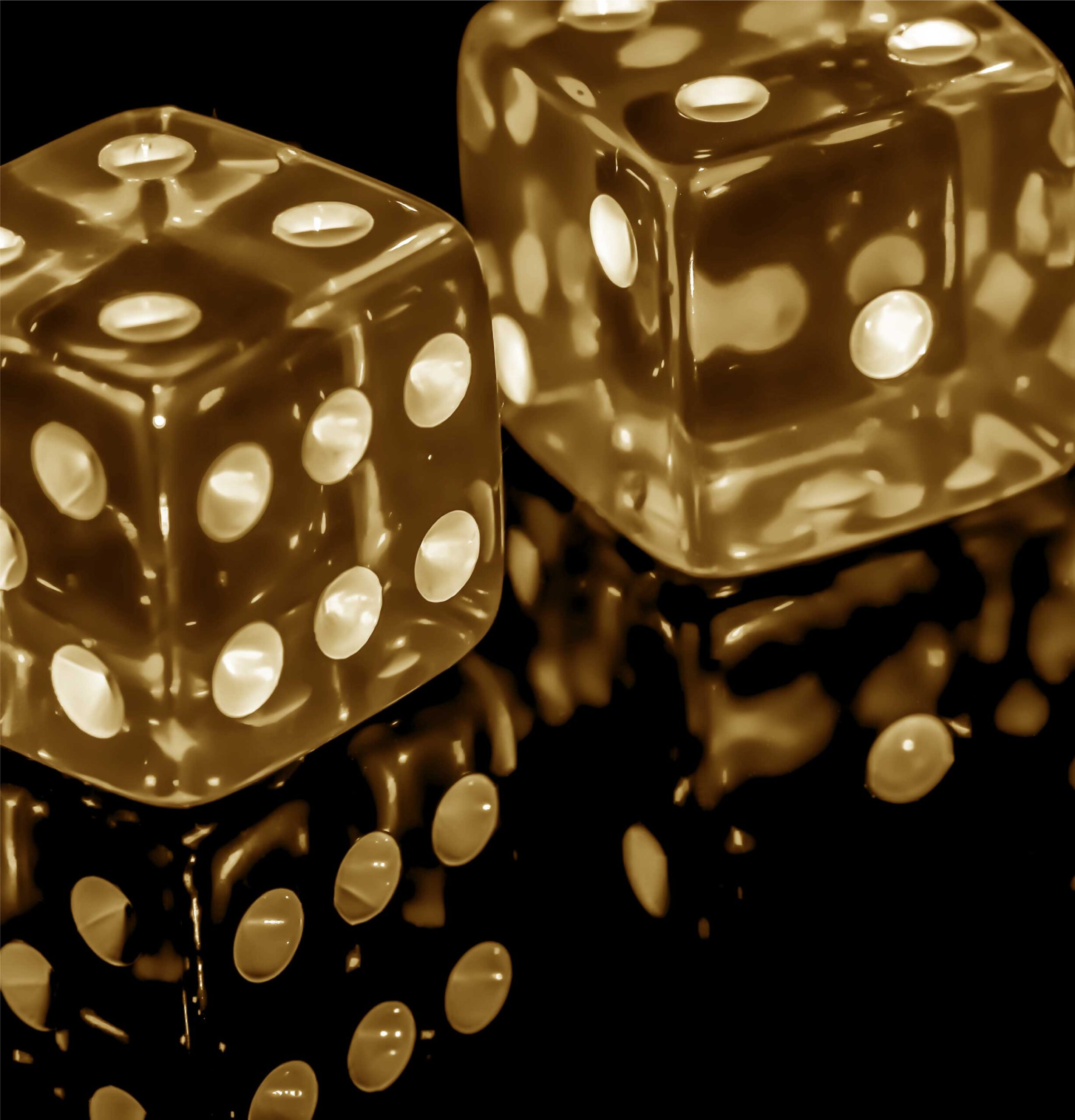 Yellow dice on a black background.