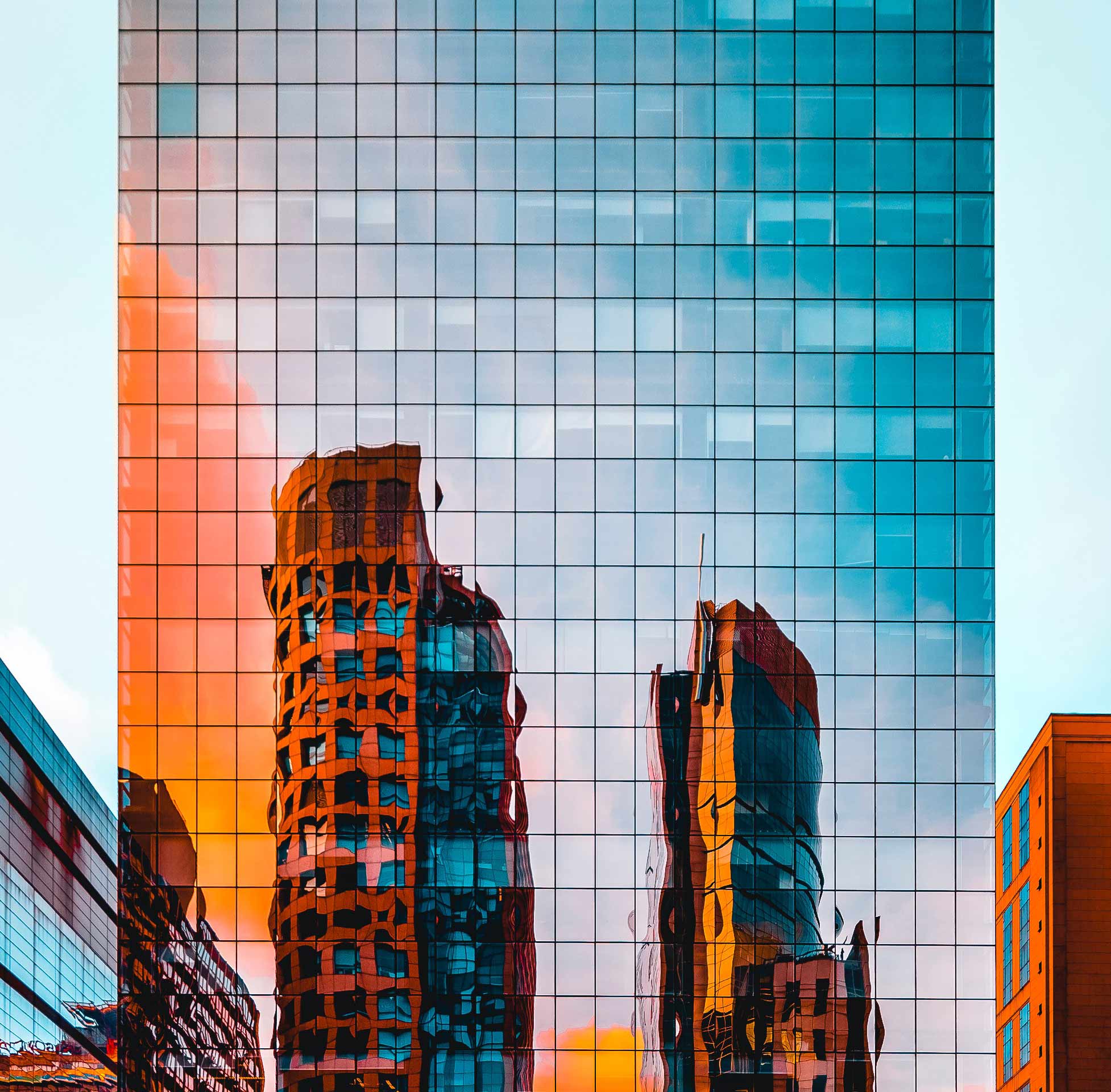 Glass building showing a reflection of another building.