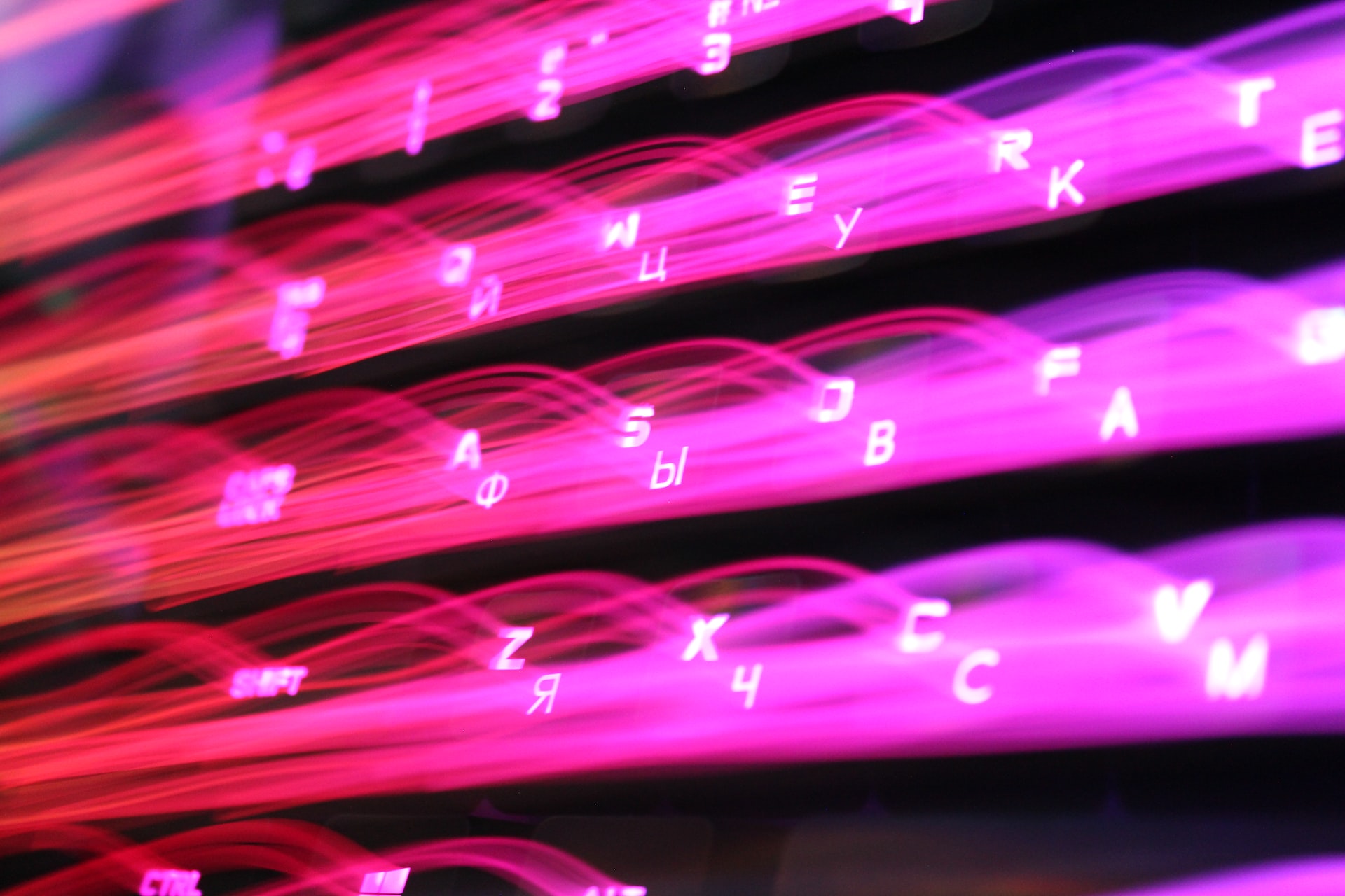 A keyboard featuring neon flared keys 