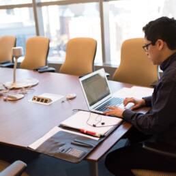 Person working on UX discovery in conference room setting