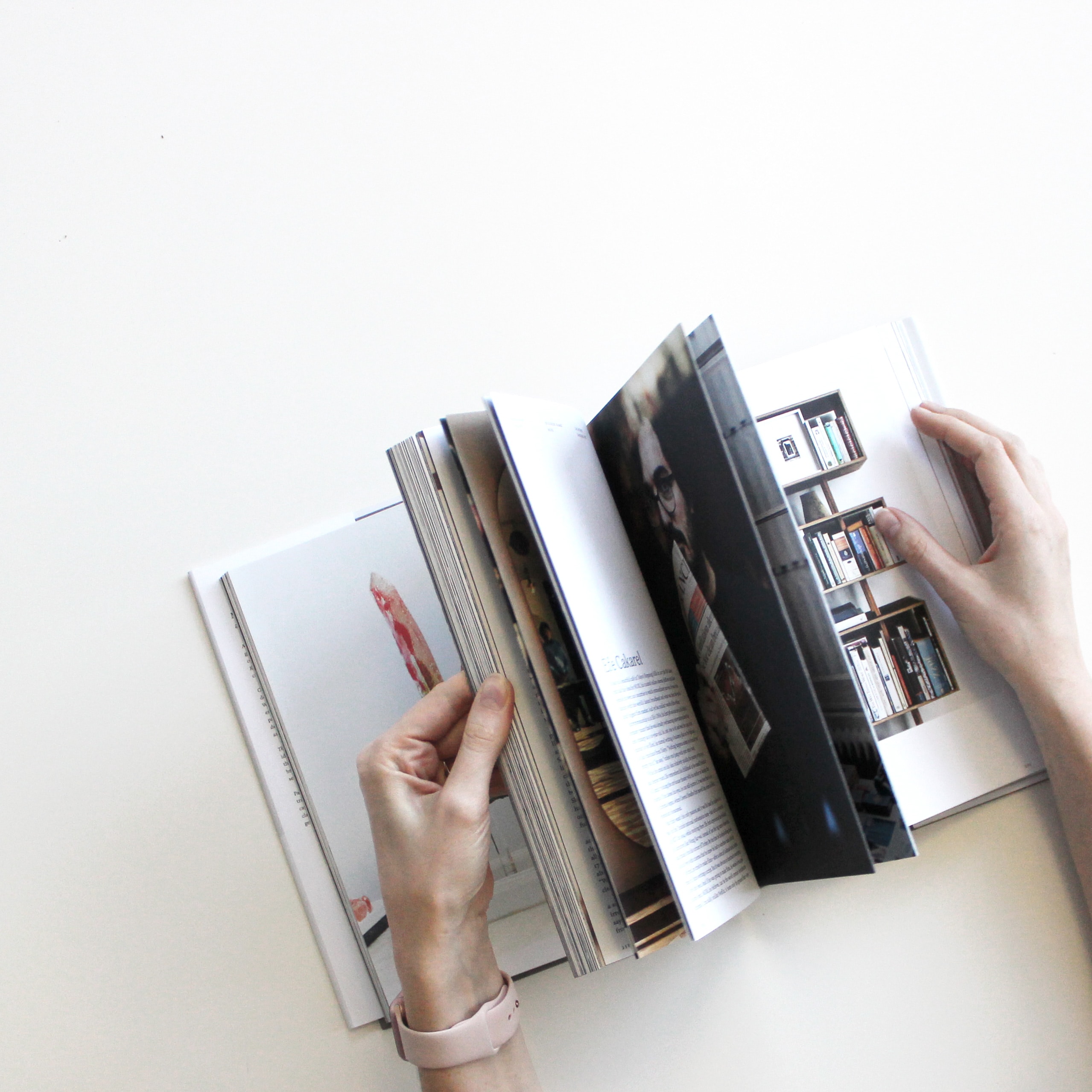 Persons hand flipping through a booklet.