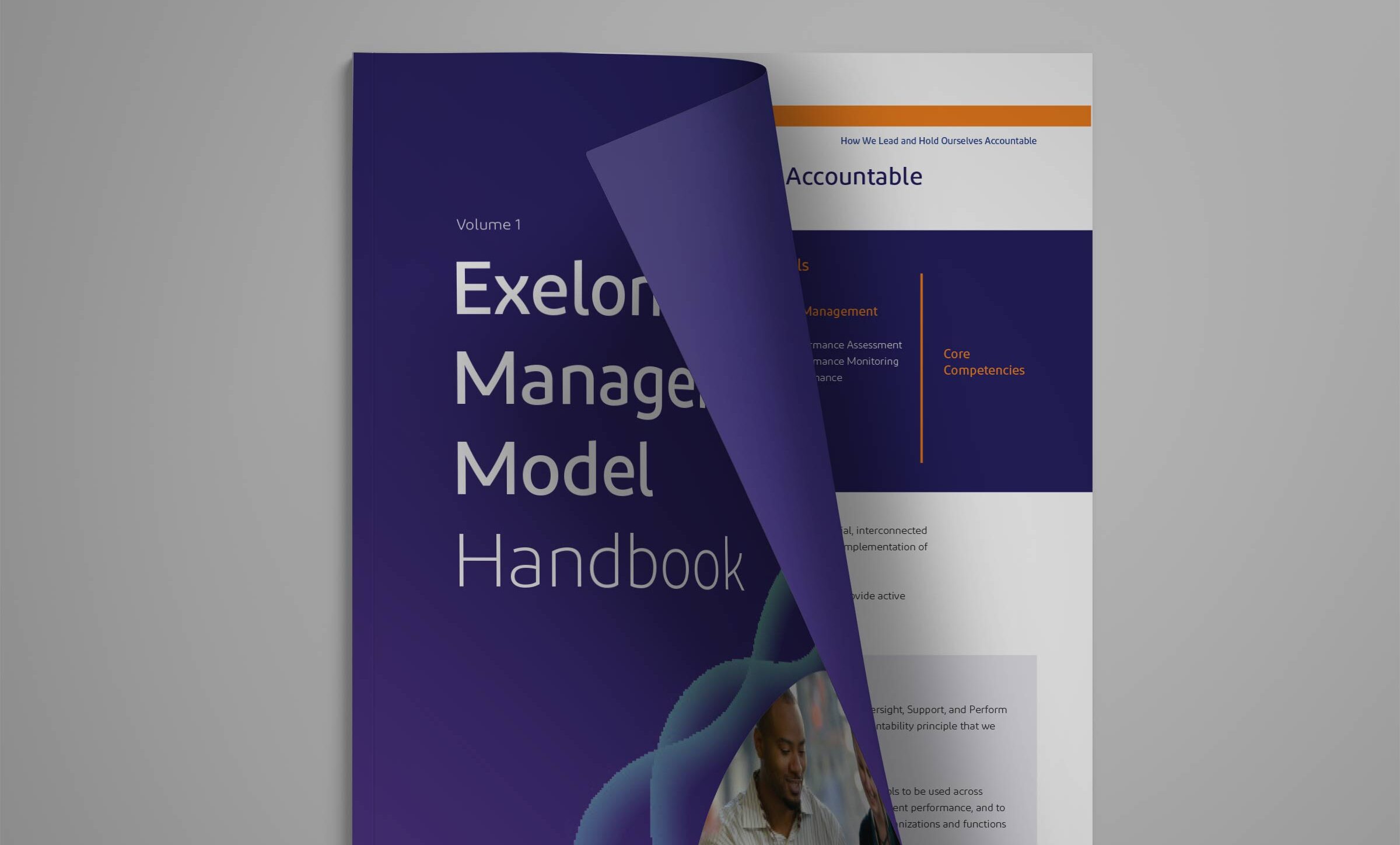 The management model handbook cover slightly opened showing a page.