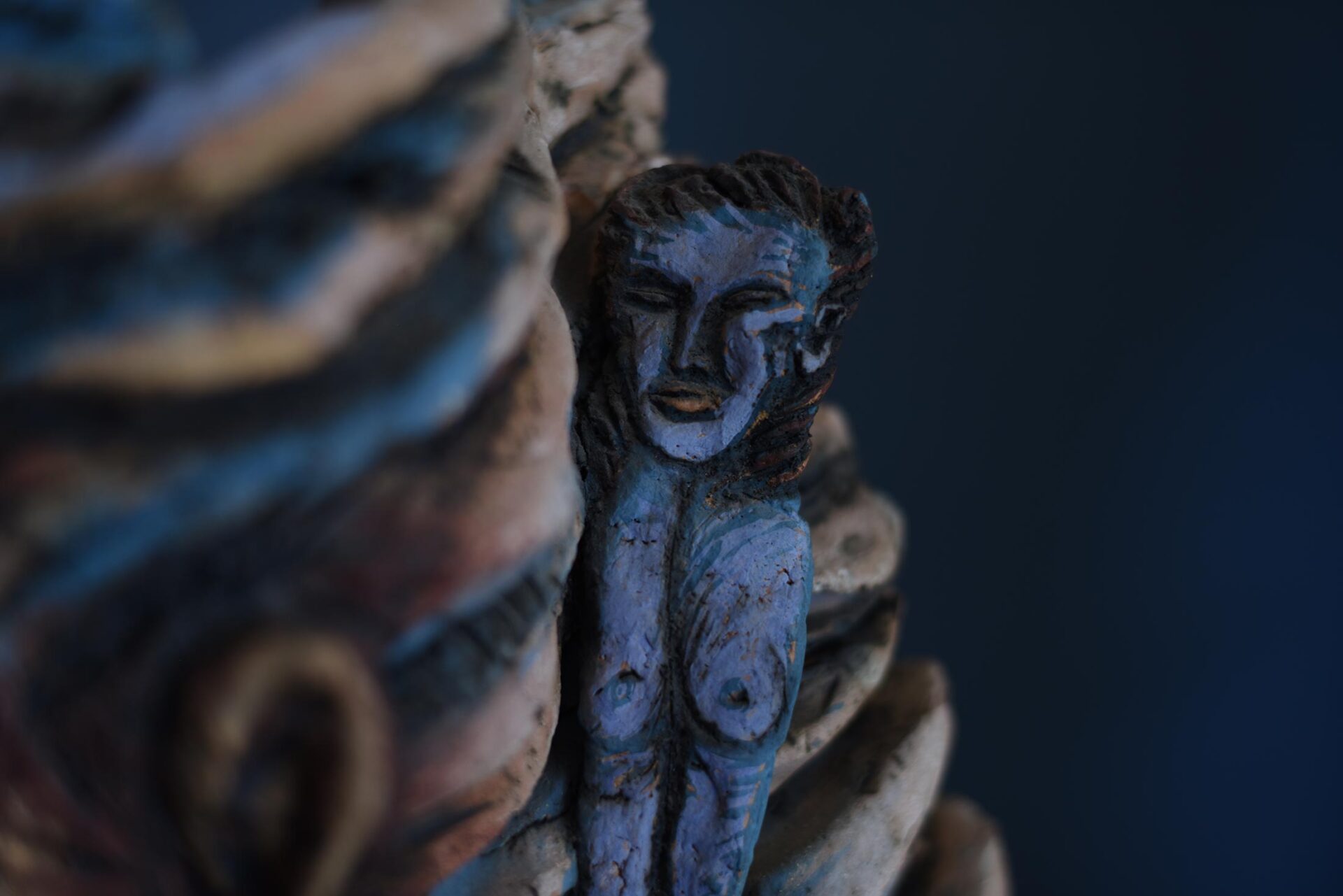 A sculpture of a small blue figure.