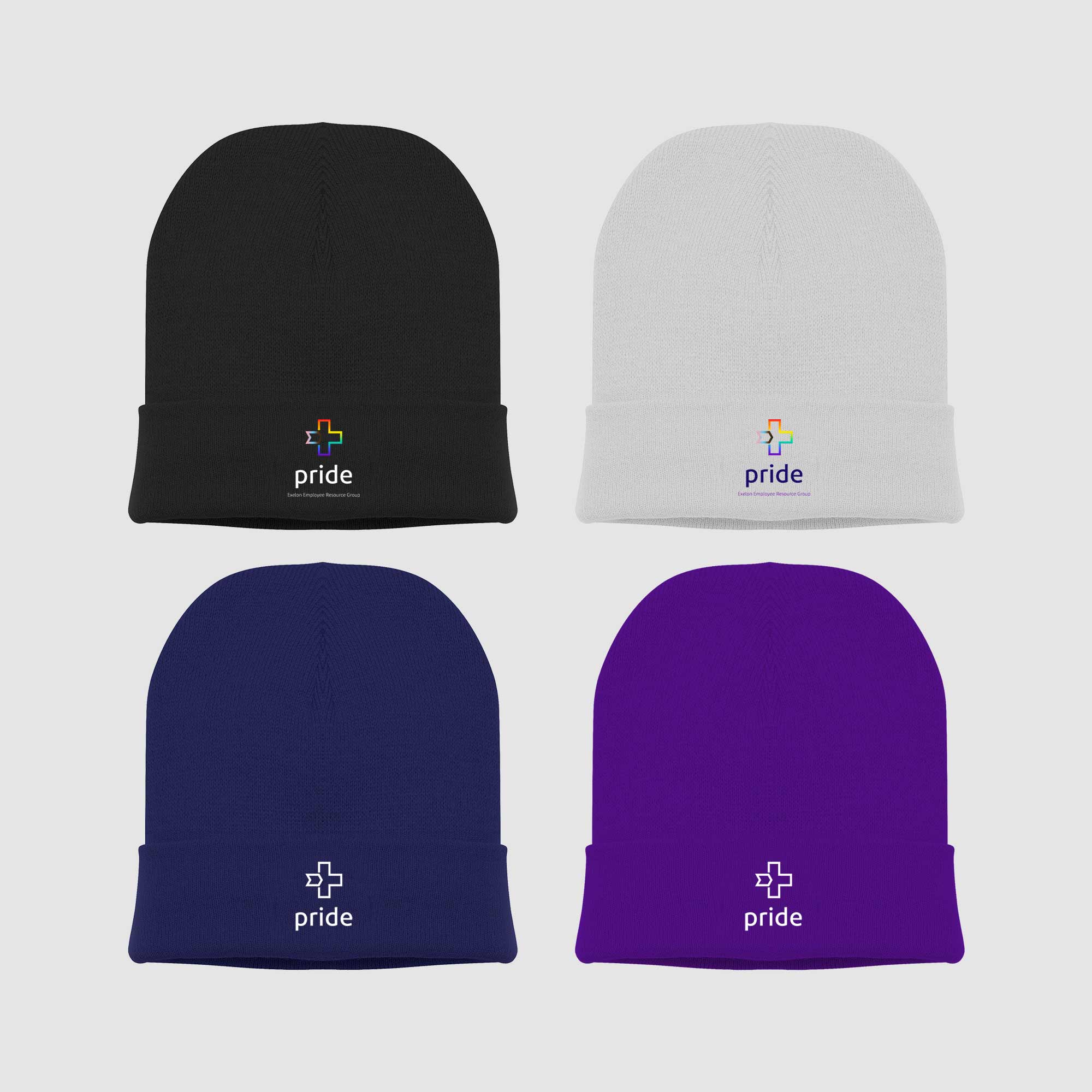 Four different colored knit hats with logos on them.