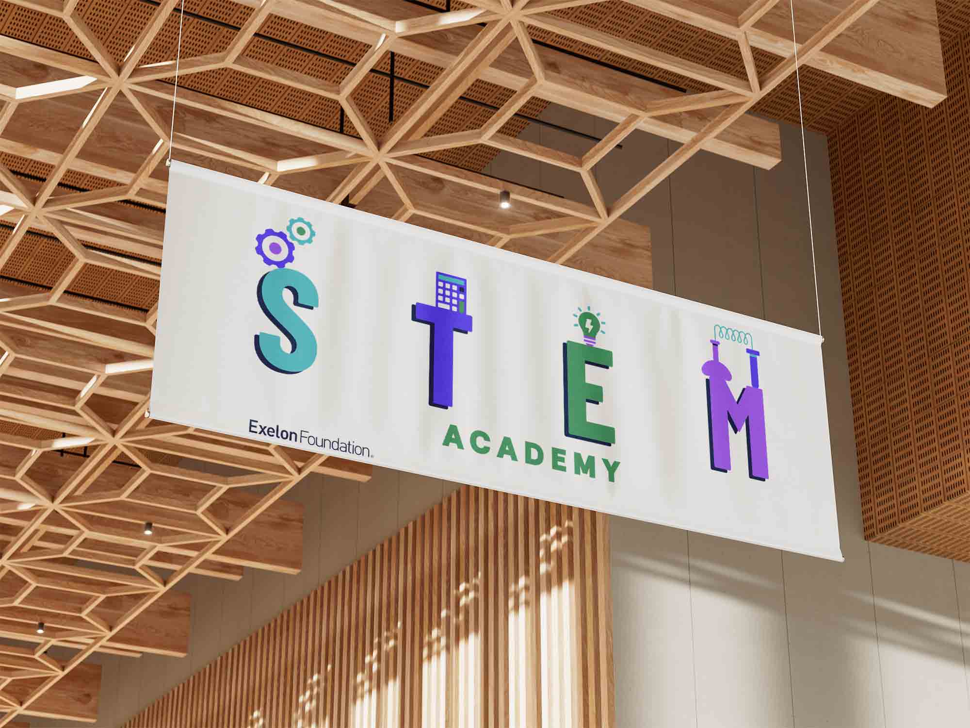 A academic logo design on a banner hanging from a wooden ceiling.