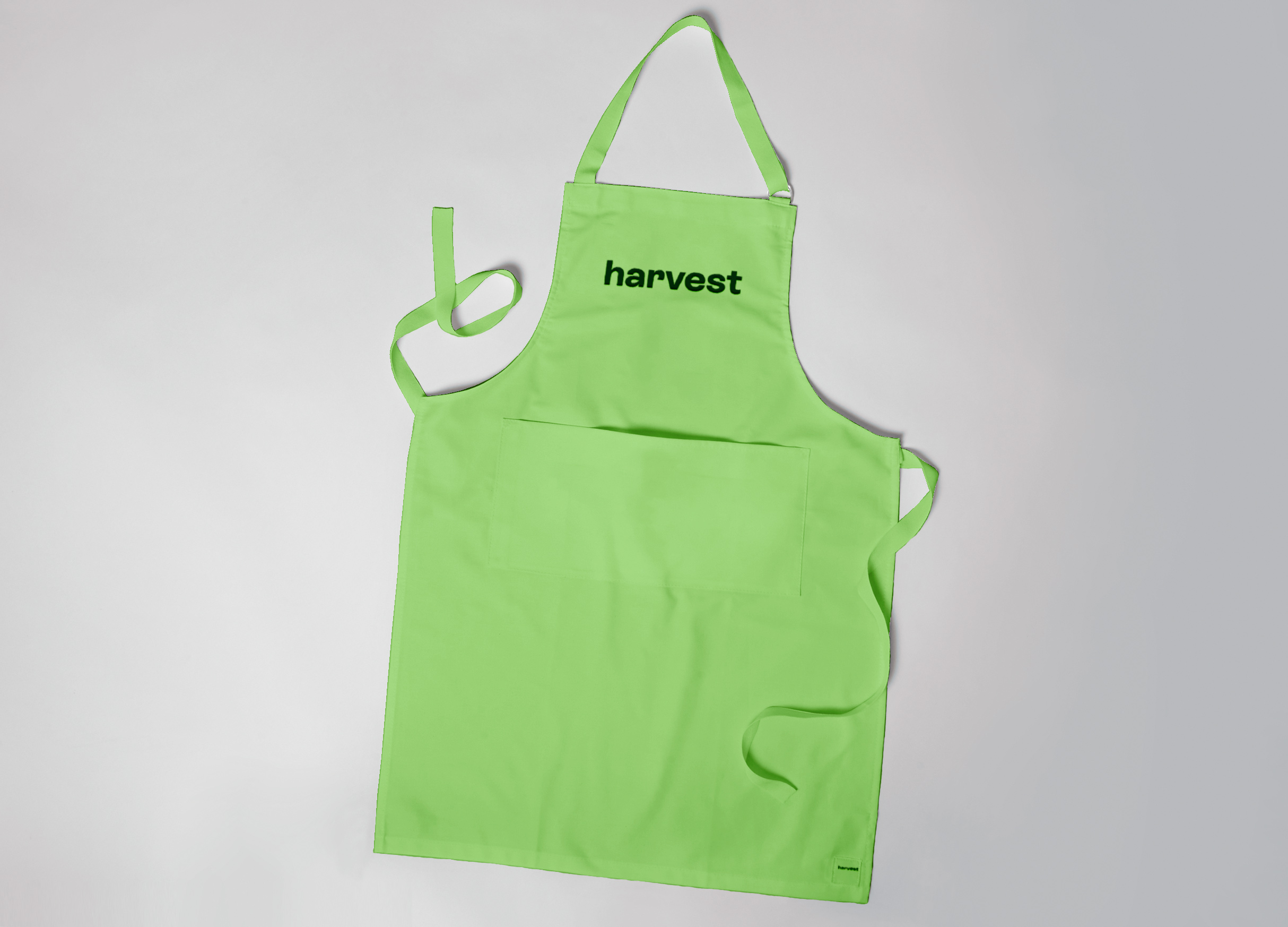 A green apron with a salad company logo on the front of it.