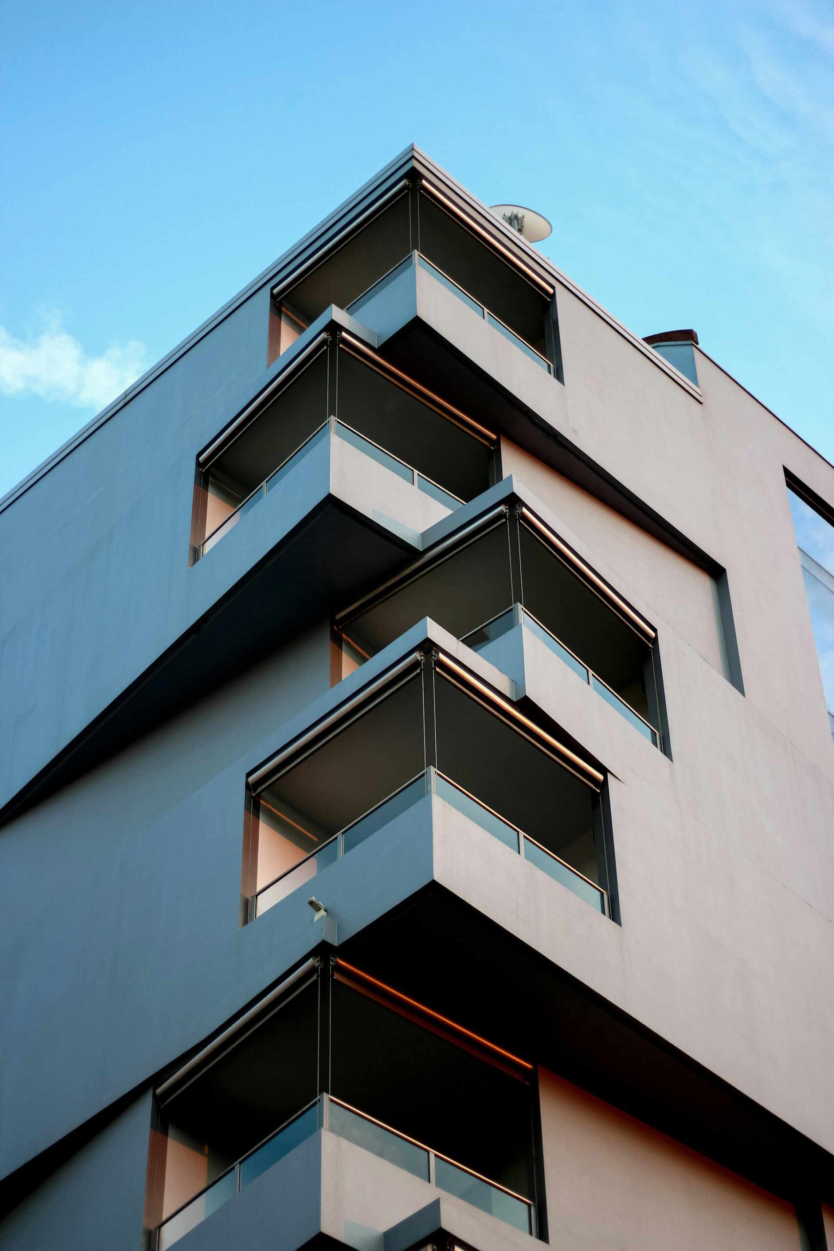 An apartment complex with multiple different balconies on separate angles.