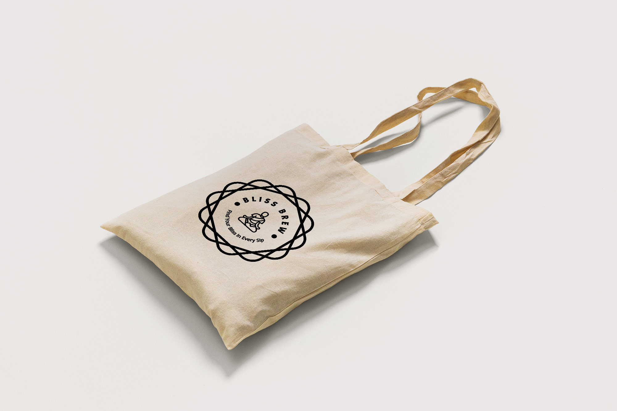 A tote bag laying down with a logo on it.