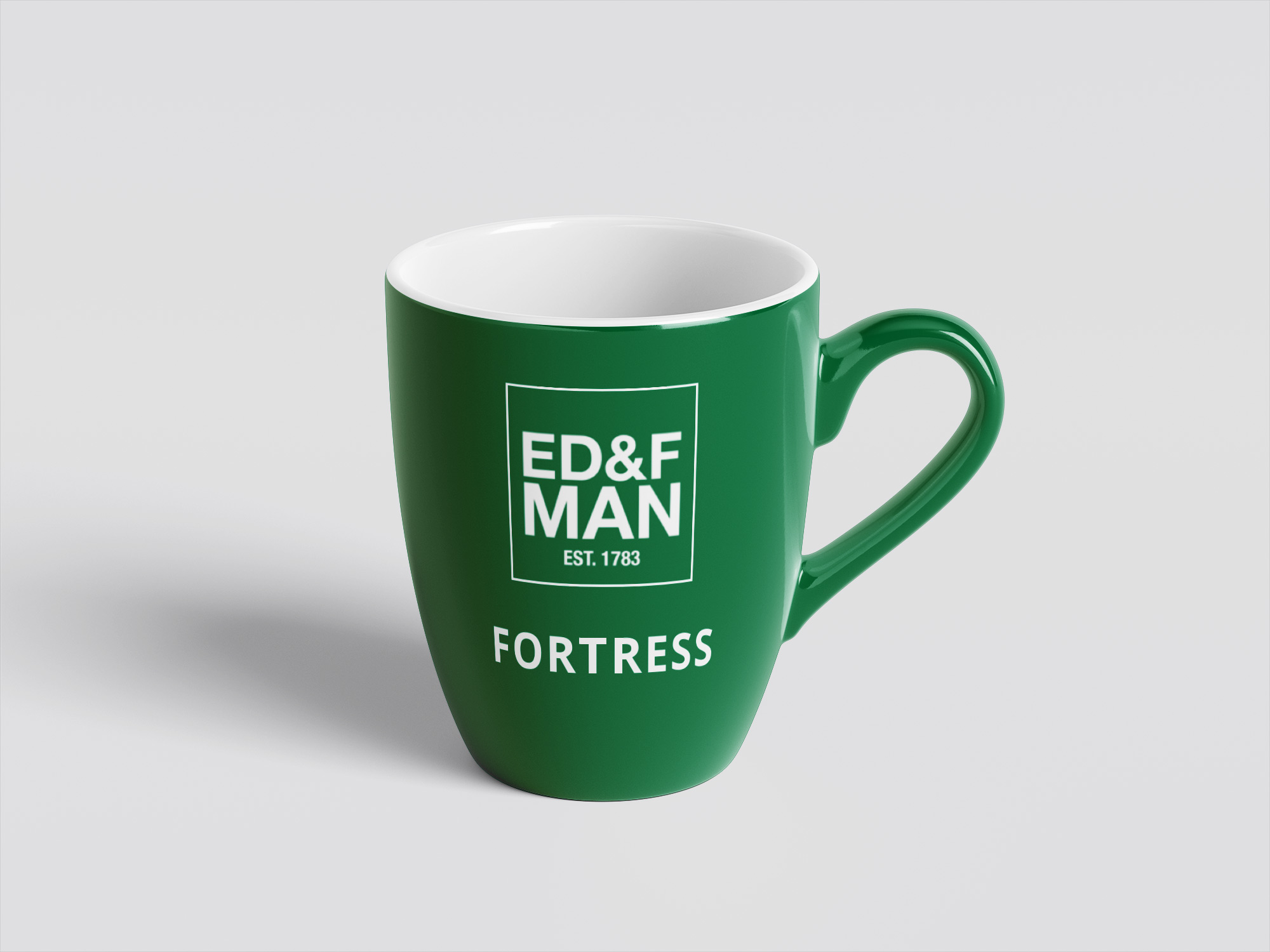 A green mug with a company logo.