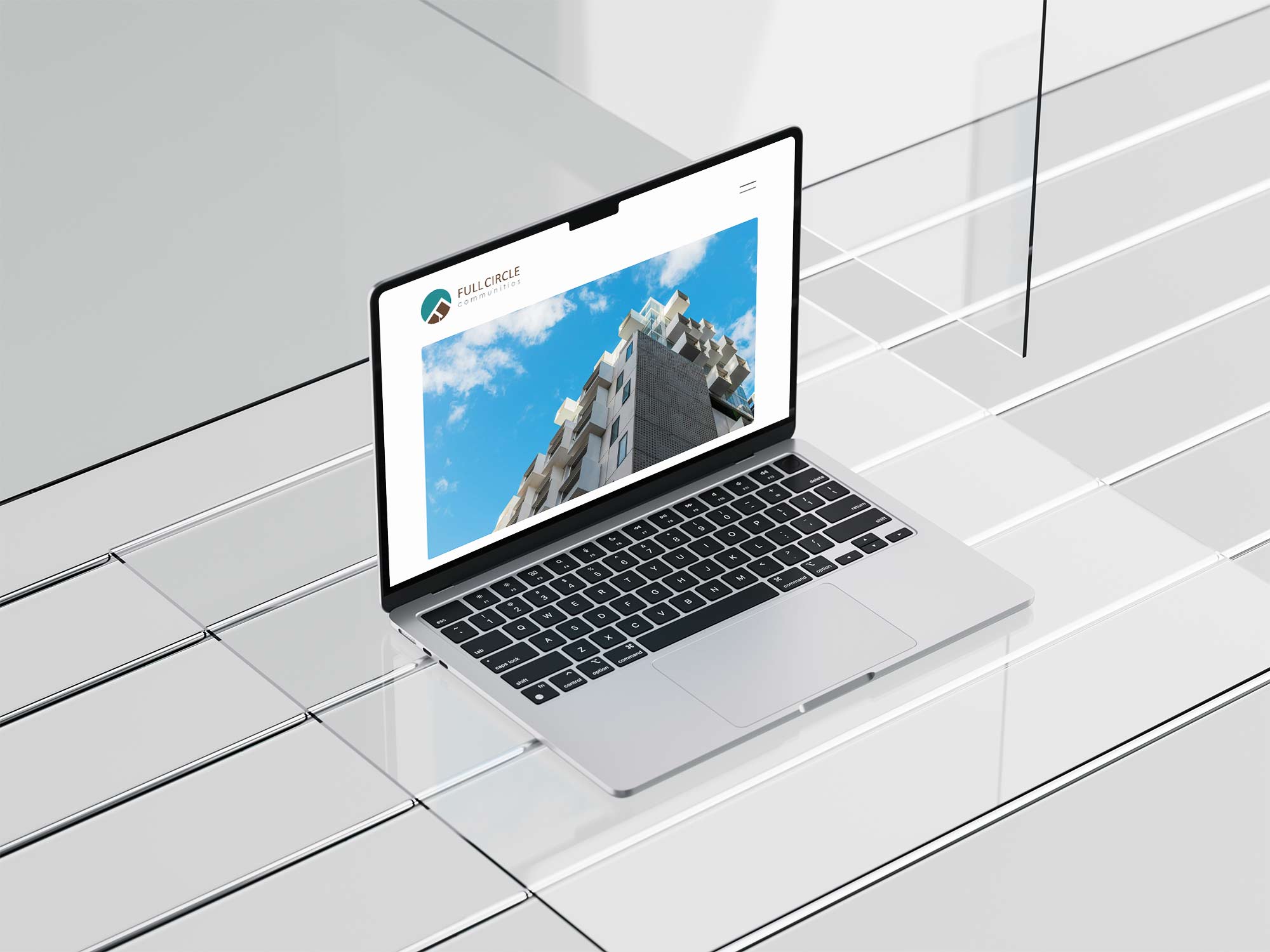 A laptop showcasing a real estate website featuring an image of a building.