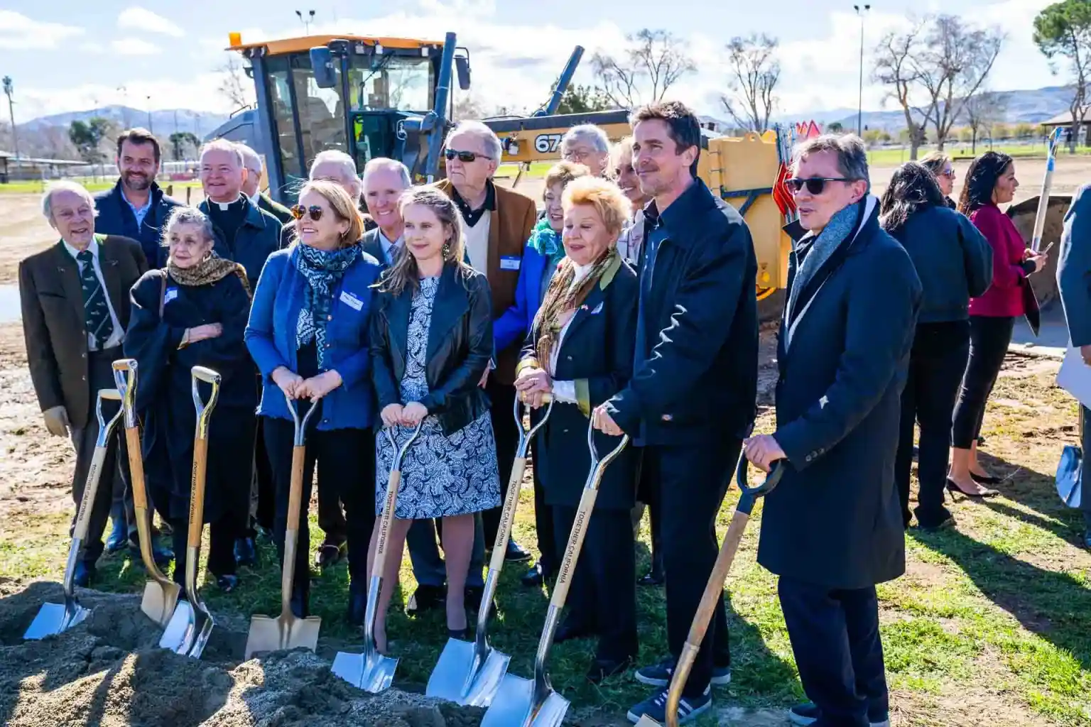 A large group smiling at ground breaking event