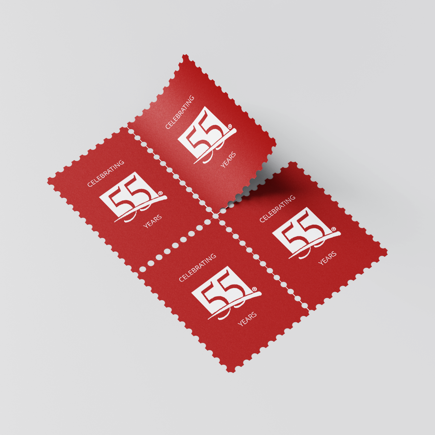 Red stamps with celebratory anniversary logo of a home and build company.