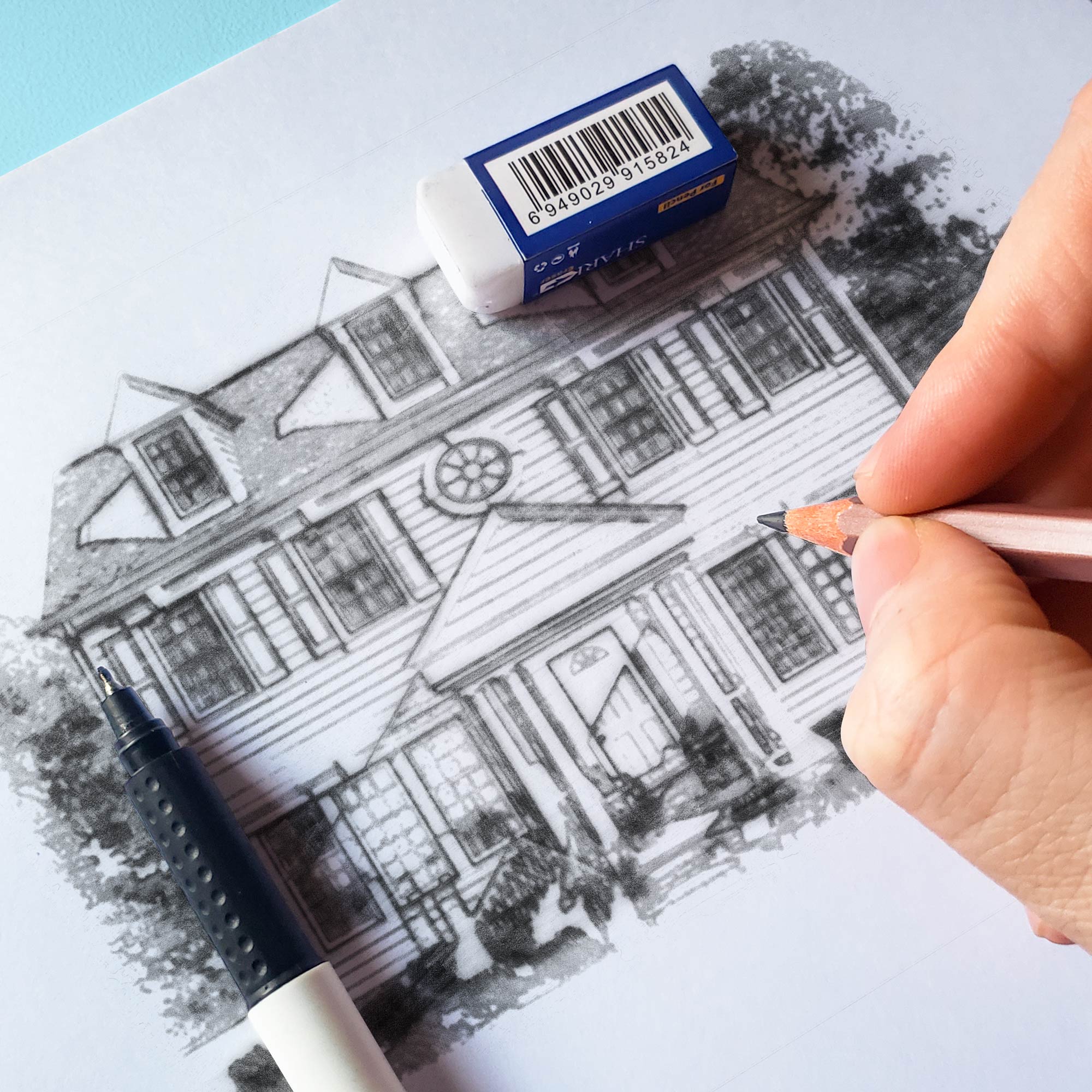 A person sketching an exterior of a home.