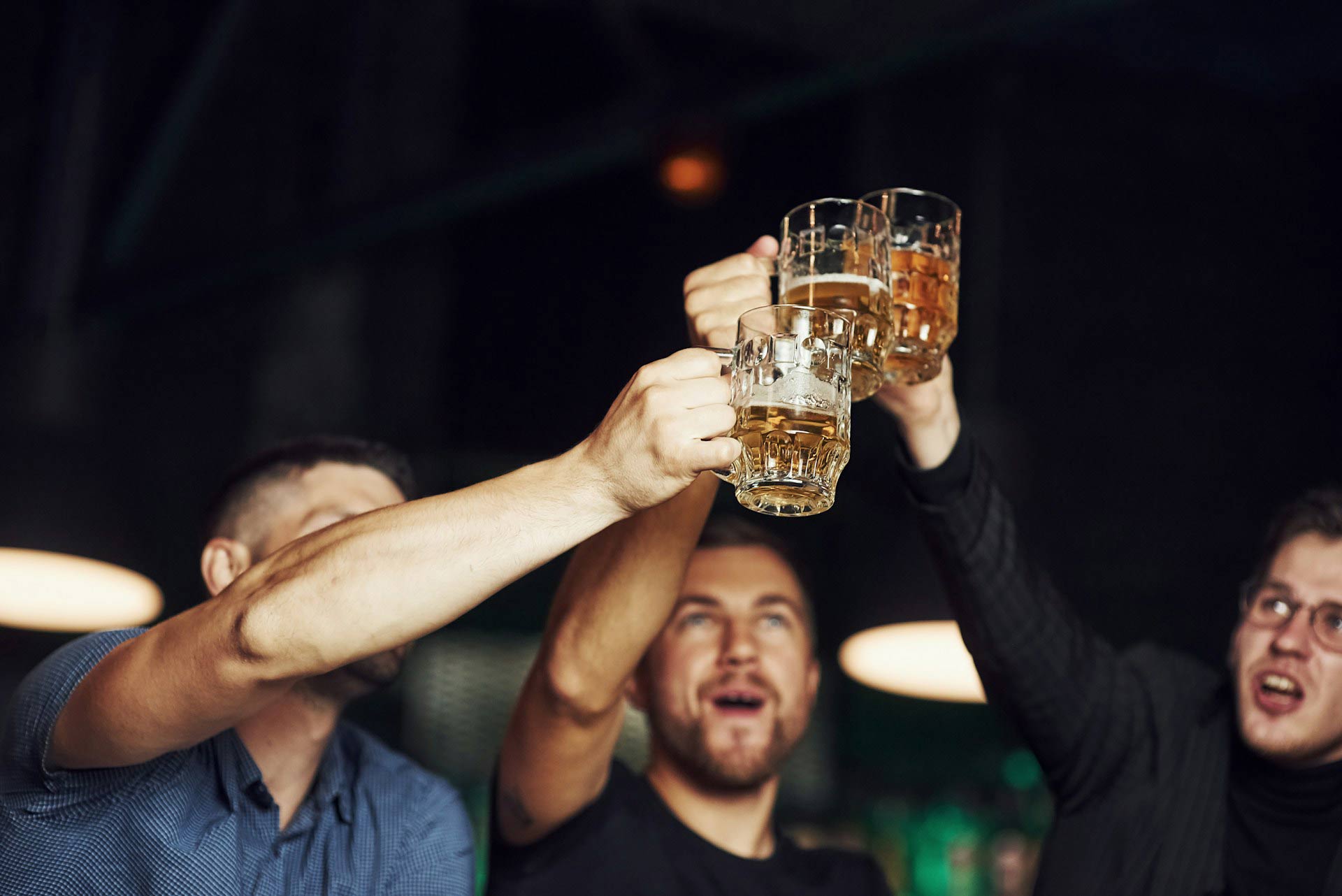 Web design—three people cheering with beer.