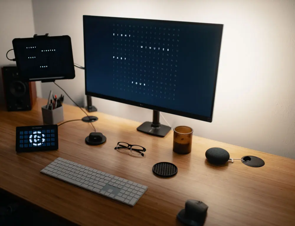 A minimal designers desk with a display turned off.