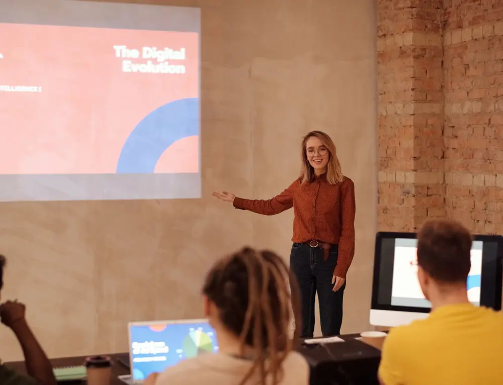 A person presents ideas in front of crowd of people.