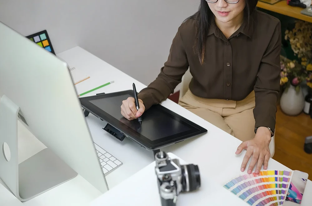 A designer illustrating on a digital tablet.