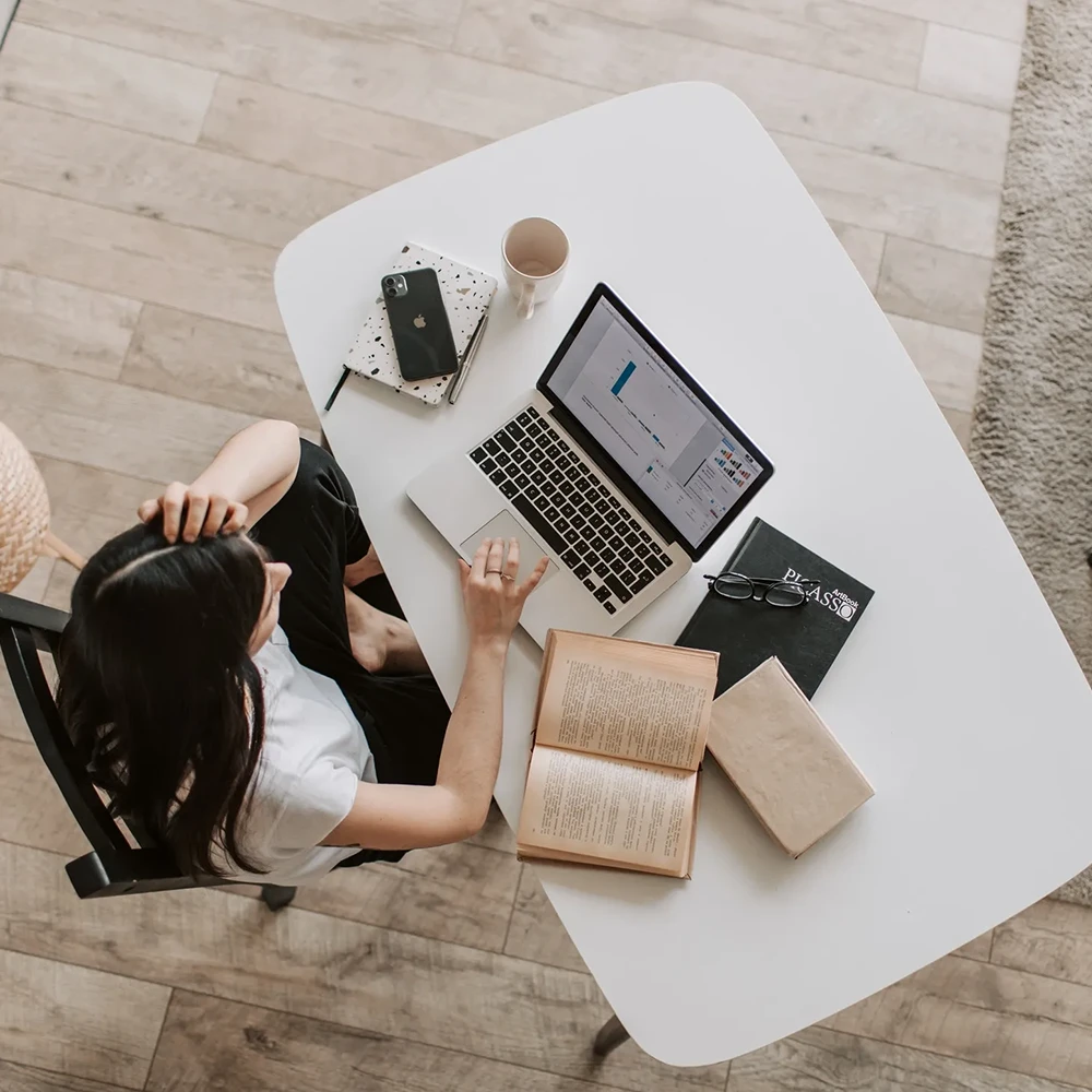 Designer working remote on their desk at home.