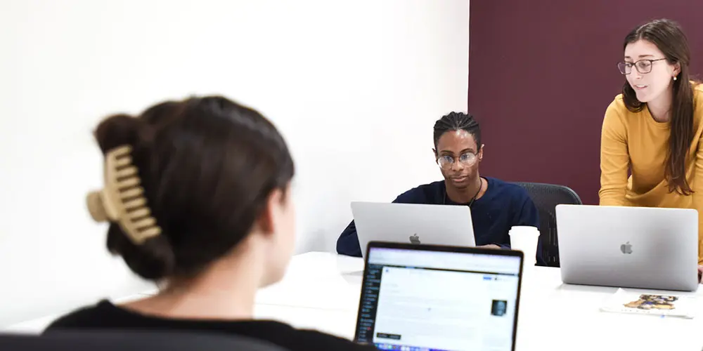 The ArtVersion team collaborating on their laptops.