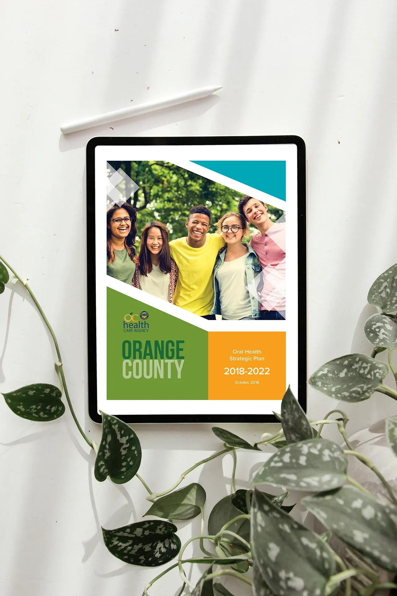 The front cover for the "Orange County Oral Health Strategic Plan 2018-2022" on a tablet display.