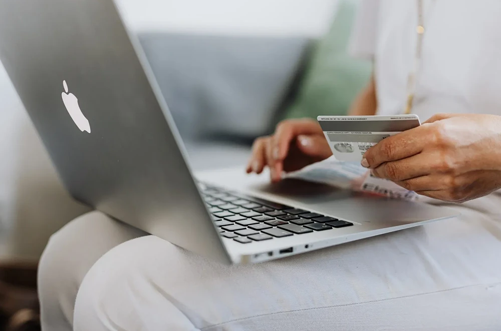 A person using their credit card to make an online purchase.
