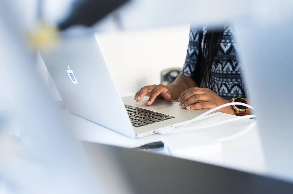 Person using track pad on a laptop.