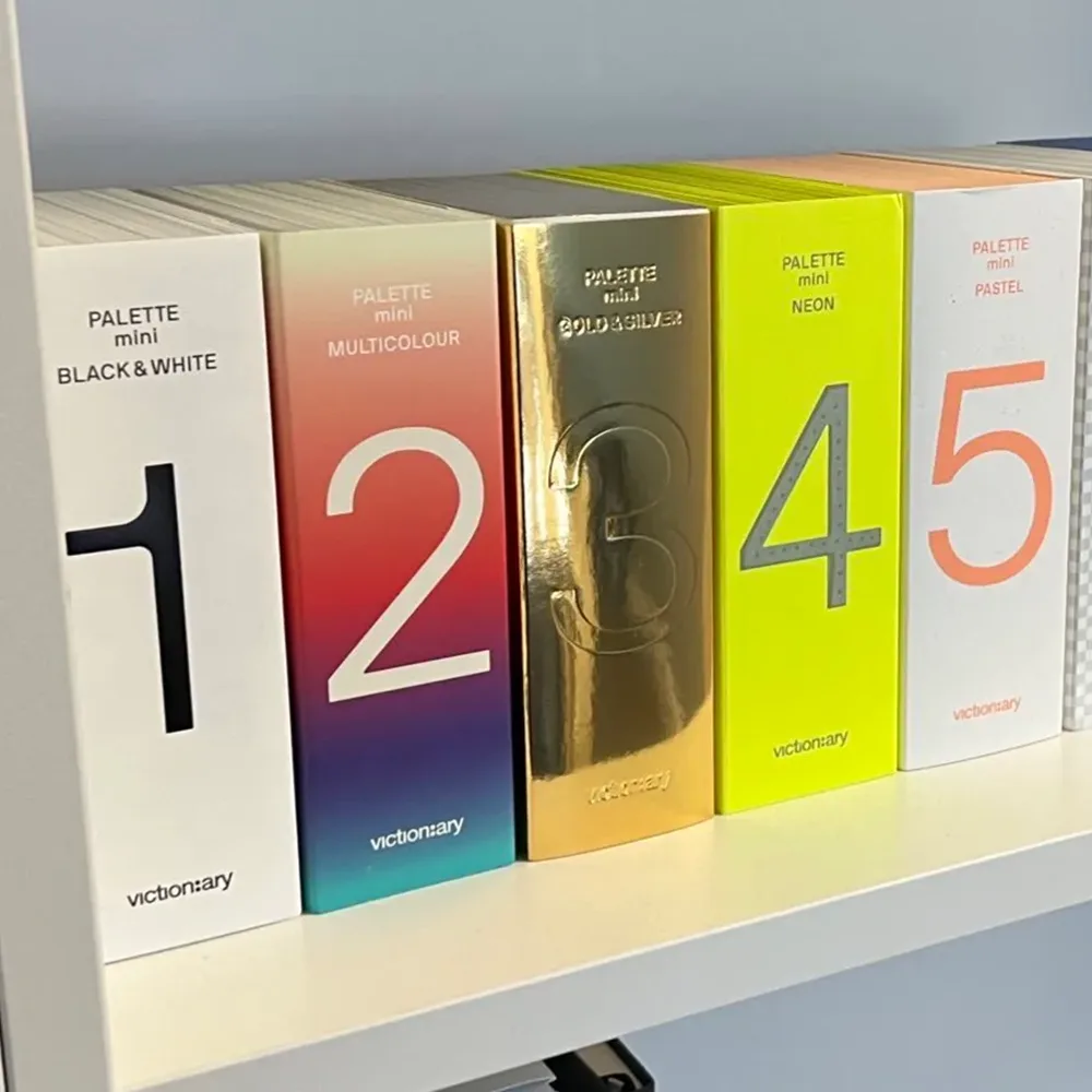 Victionary books sitting on a shelf.