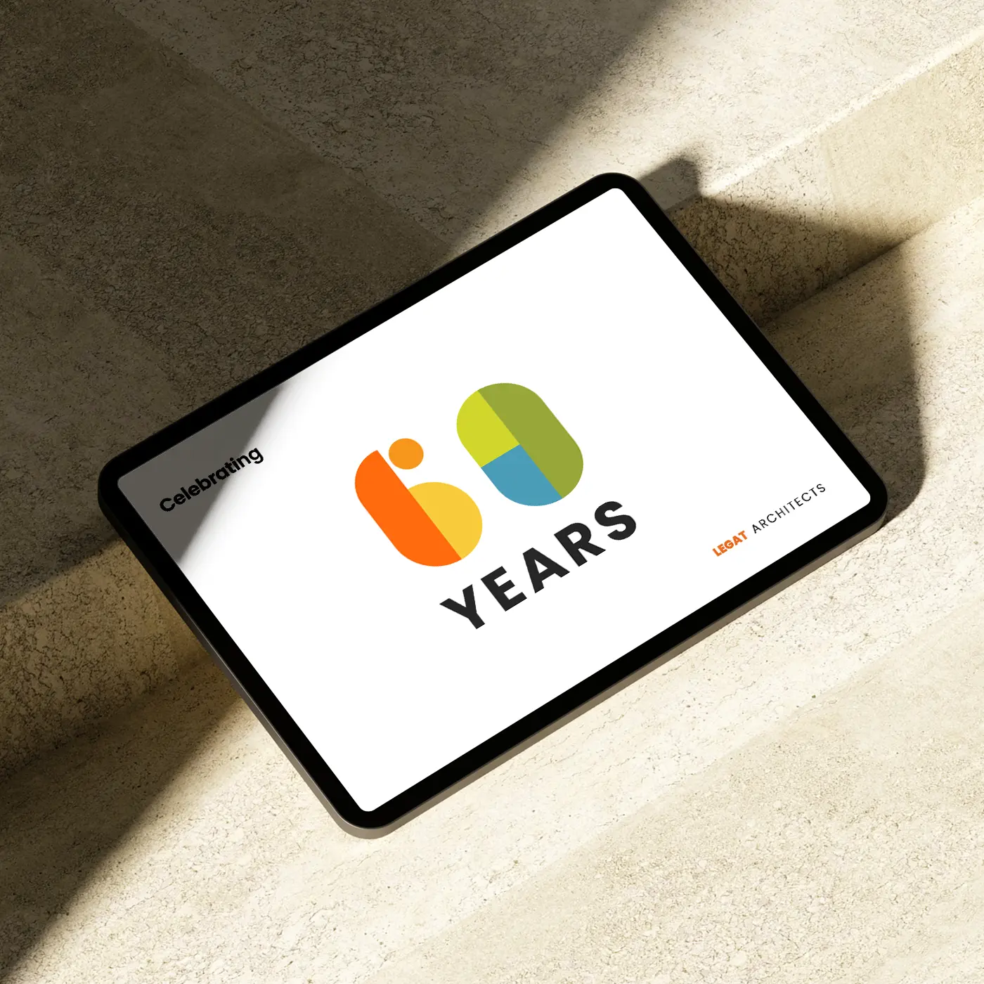Anniversary logo design for an architects firm celebrating 60 years displayed on an iPad device.