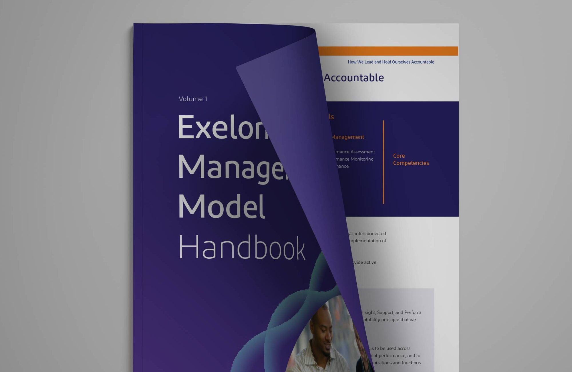 The management model handbook cover slightly opened showing a page.